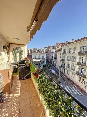 a balcony with plants and a view of a city at A 2 pas des plages et centre 324L TER in Cannes