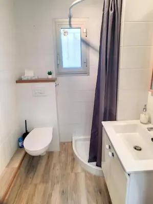 a bathroom with a toilet and a sink at Superbe studio jardin, terrasse, piscine 307L Kali in Cannes