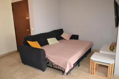 a bed in a small room with a couch at Cannes La Baronne in Cannes
