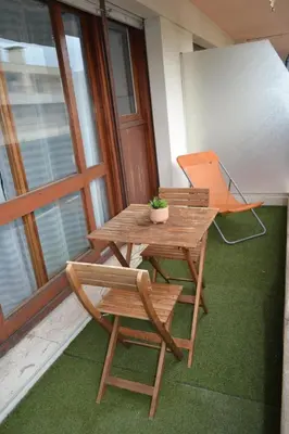 a wooden table and two chairs and a white board at Cannes La Baronne in Cannes