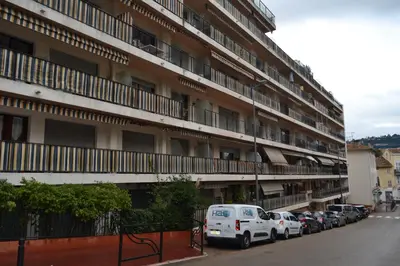 an apartment building with cars parked in front of it at Cannes La Baronne in Cannes