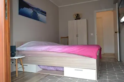 a bedroom with a large bed with pink sheets at Cannes La Baronne in Cannes