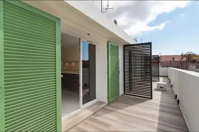 a balcony with green and white shutters on a building at 3 bedrooms 2 terraces in Cannes in Cannes