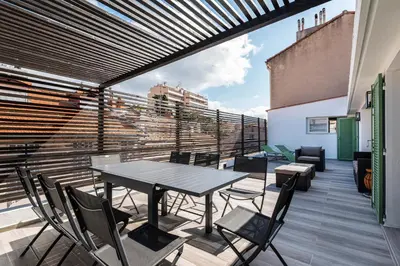 a patio with a table and chairs on a balcony at 3 bedrooms 2 terraces in Cannes in Cannes