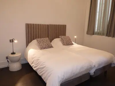 a bedroom with a white bed with two pillows on it at Arthur Properties Croisette in Cannes