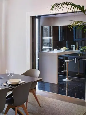 a kitchen and dining room with a table and chairs at Arthur Properties Croisette in Cannes
