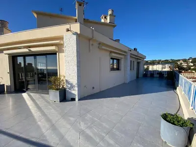 a large patio with a building with a balcony at C010 - Magnifique Appartement Toit Terrasse in Cannes