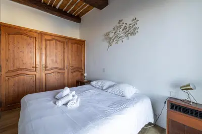 a bedroom with a bed with white towels on it at L'HONORAT vue mer et port, à côté des plages du Midi et proche du Palais in Cannes