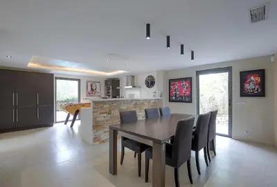 a kitchen and dining room with a table and chairs at Villa Spacieuse - Piscine chauffée - Climatisé in Mougins