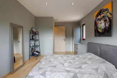 a bedroom with a bed and a painting on the wall at Villa Spacieuse - Piscine chauffée - Climatisé in Mougins