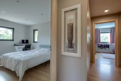a bedroom with a bed and a picture of a vase at Villa Spacieuse - Piscine chauffée - Climatisé in Mougins