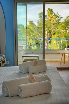 a bed with towels on it with a large window at Immogroom -Studio-Clim-Sea view in Cannes