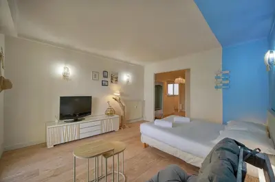 a large bedroom with a bed and a tv at Immogroom -Studio-Clim-Sea view in Cannes