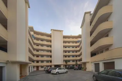 a large building with cars parked in a parking lot at Immogroom -Studio-Clim-Sea view in Cannes