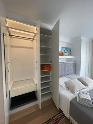 a bedroom with a bed and a white closet at Superbe studio pour congrés au coeur de Cannes in Cannes