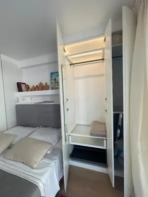 a small bedroom with a bed and a closet at Superbe studio pour congrés au coeur de Cannes in Cannes