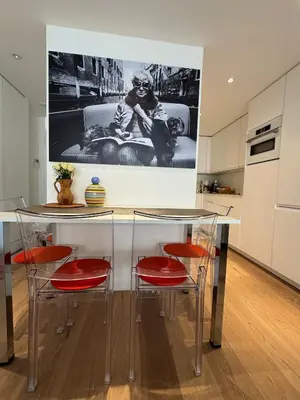 a kitchen with a table with chairs and a picture on the wall at Superbe studio pour congrés au coeur de Cannes in Cannes