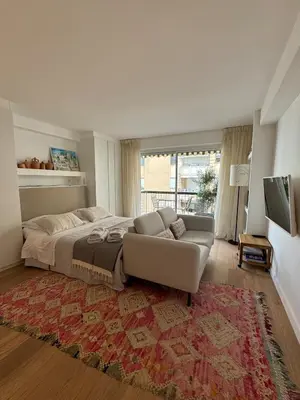 a large bedroom with a bed and a couch at Superbe studio pour congrés au coeur de Cannes in Cannes