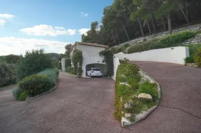 a white car is parked in a garage at IMMOGROOM - Exceptional Villa - Sea View - Pool in Vallauris