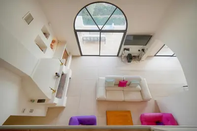 a living room with a couch and a window at IMMOGROOM - Exceptional Villa - Sea View - Pool in Vallauris