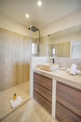 a bathroom with a sink and a large mirror at IMMOGROOM - Exceptional Villa - Sea View - Pool in Vallauris