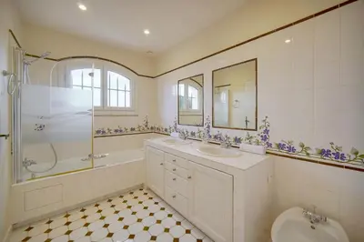 a bathroom with two sinks and a shower and a toilet at IMMOGROOM - Exceptional Villa - Sea View - Pool in Vallauris