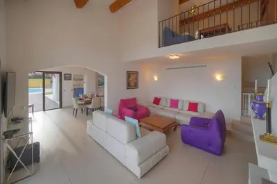 a living room with two couches and a table at IMMOGROOM - Exceptional Villa - Sea View - Pool in Vallauris