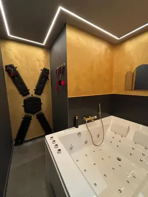 a bathroom with a tub with two cameras on the wall at La Suite Tentation in Cannes
