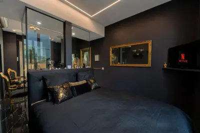 a bedroom with a bed and a mirror at La Suite Tentation in Cannes