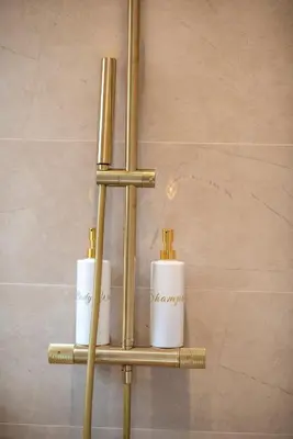 a shelf with three toiletries on it in a bathroom at La Suite Jardin Secret in Cannes
