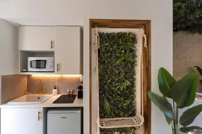 a kitchen with a green wall in the doorway at La Suite Jardin Secret in Cannes