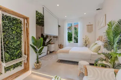 a bedroom with a bed and plants in it at La Suite Jardin Secret in Cannes