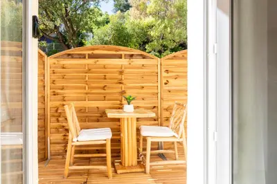 a patio with a table and chairs on a porch at La Suite Jardin Secret in Cannes