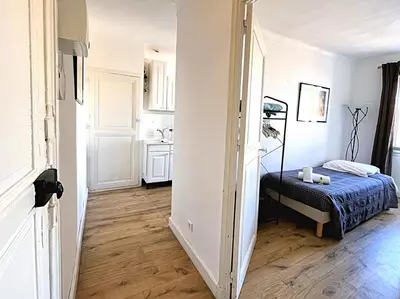 a small bedroom with a bed and a kitchen at Sunny 1 Bedroom Rue Commandant André in Cannes