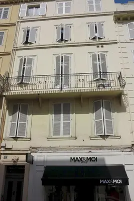 a building with a balcony on the side of it at Sunny 1 Bedroom Rue Commandant André in Cannes