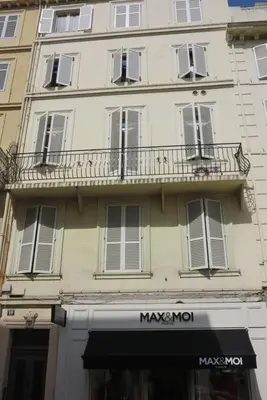 a building with a balcony on the side of it at Sunny 1 Bedroom Rue Commandant André in Cannes