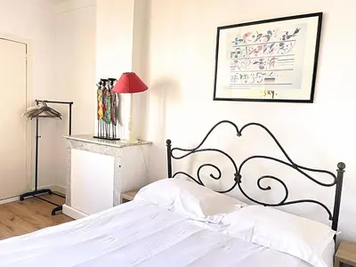 a bedroom with a white bed and a red lamp at Sunny 1 Bedroom Rue Commandant André in Cannes
