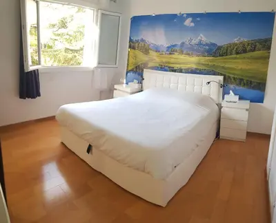 a bedroom with a large bed with a painting on the wall at Sunshine in Cannes in Cannes