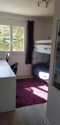 a room with a bed and a desk and a window at Sunshine in Cannes in Cannes
