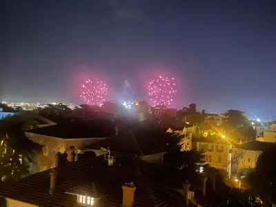 a firework display in the sky over a city at night at appartement centre ville cannes vue mer in Cannes