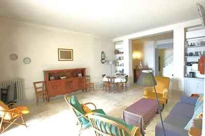 a living room with a couch and chairs and a table at Sea View Apartment in Cannes