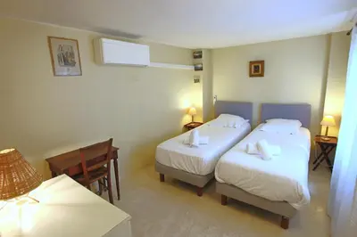 a hotel room with two beds and a table at Sea View Apartment in Cannes