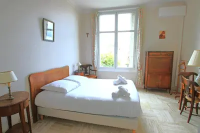 a bedroom with a bed with two teddy bears on it at Sea View Apartment in Cannes
