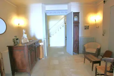 a living room with aoyer with a staircase and a table at Sea View Apartment in Cannes