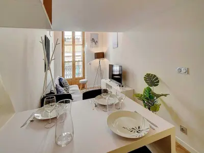 a living room with a table with wine glasses on it at Bright duplex - Cannes Centre - Mobility lease in Cannes