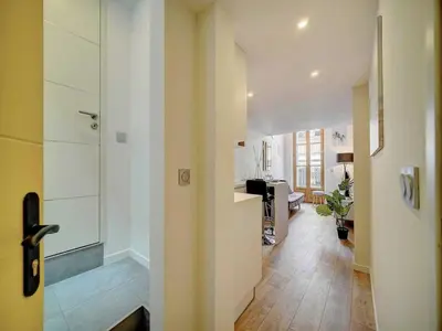 a room with a kitchen and a hallway with a door at Bright duplex - Cannes Centre - Mobility lease in Cannes