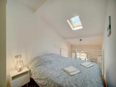 a bedroom with a bed with two towels on it at Bright duplex - Cannes Centre - Mobility lease in Cannes