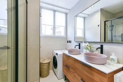 a bathroom with two sinks and a washing machine at Cosy apartment with parking - Cannes - Mobility Lease in Cannes