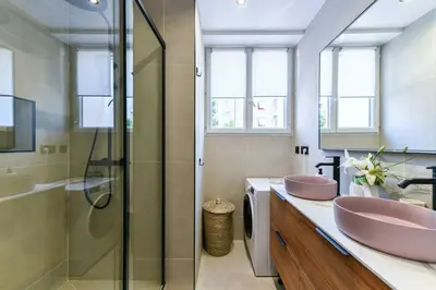 a bathroom with two pink sinks and a shower at Cosy apartment with parking - Cannes - Mobility Lease in Cannes