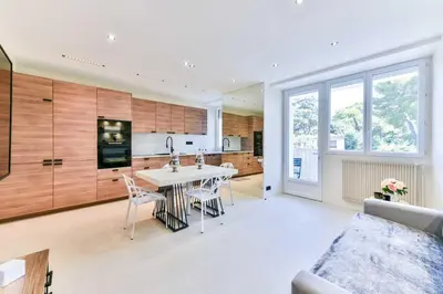 a kitchen and living room with a table and chairs at Cosy apartment with parking - Cannes - Mobility Lease in Cannes